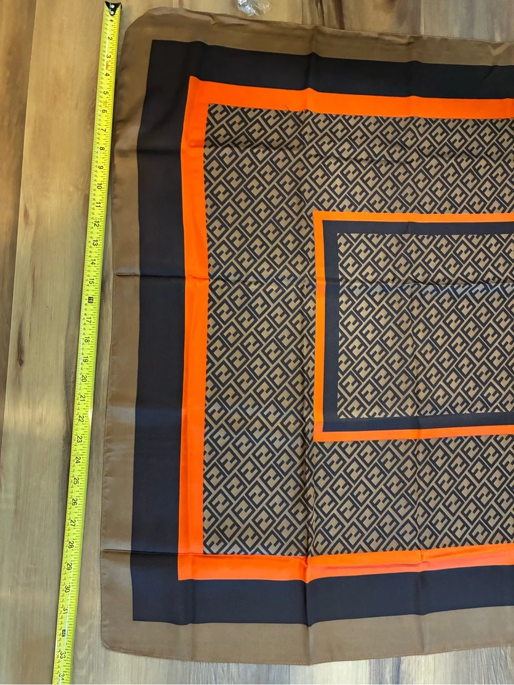 NWT brown and orange & tan geometric scarf. Polyester w/Silk feel. Approx 70 in